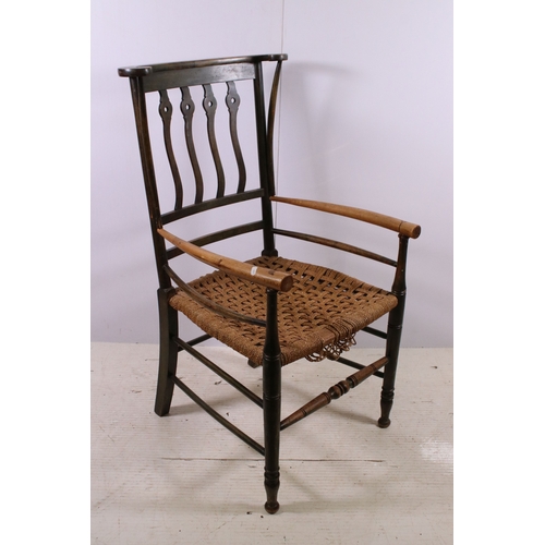 668 - Two Arts and Crafts slat back open arm chairs, curved back rail with four wavy pierced back splats a... 