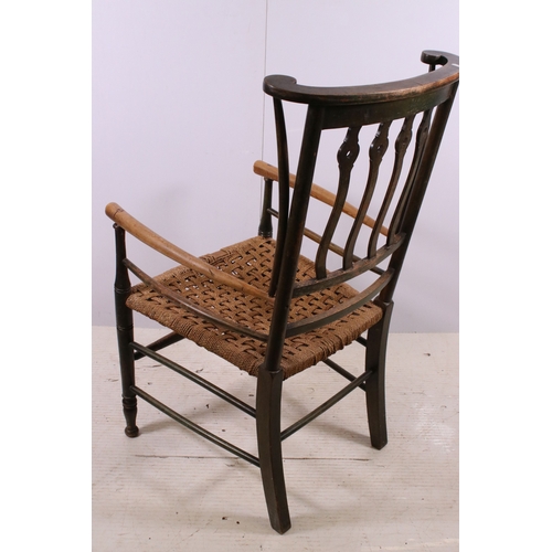 668 - Two Arts and Crafts slat back open arm chairs, curved back rail with four wavy pierced back splats a... 