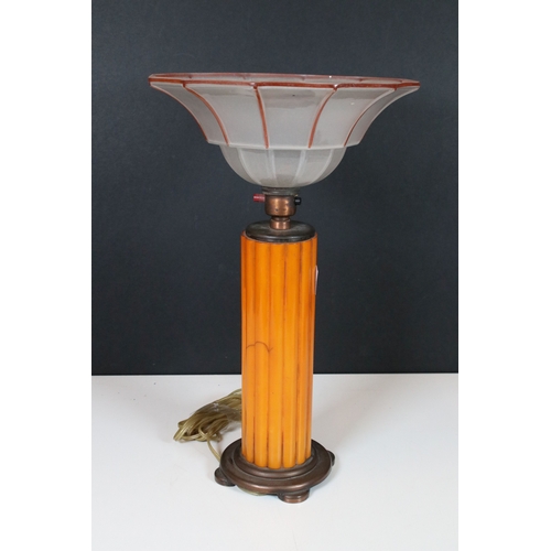 332 - A collection of Art Deco era bakelite to include a column table lamp, napkin rings and an oversized ... 