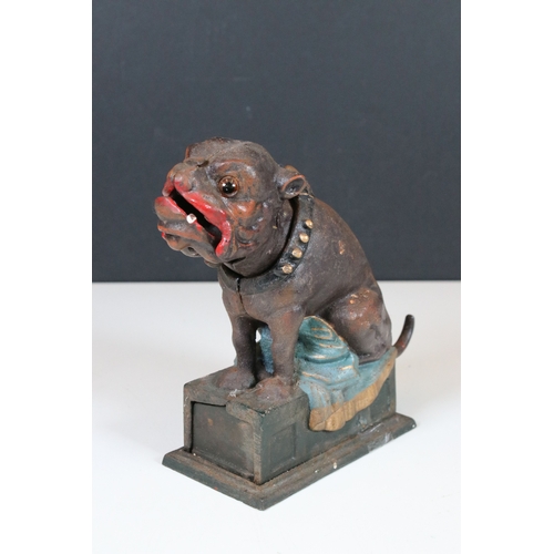 377 - A cast iron Bull Dog money bank together with a cast iron dinosaur.