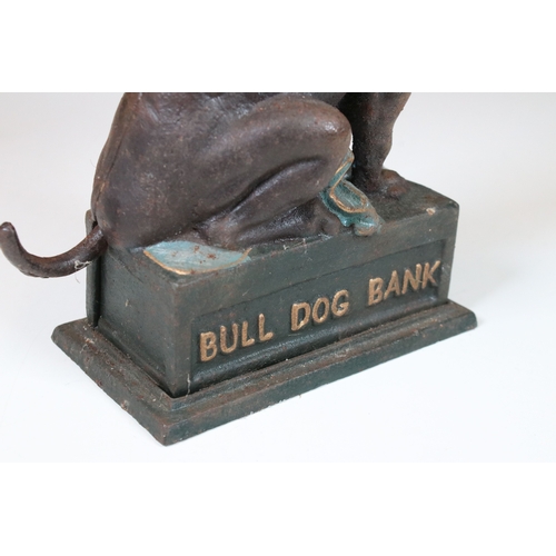 377 - A cast iron Bull Dog money bank together with a cast iron dinosaur.