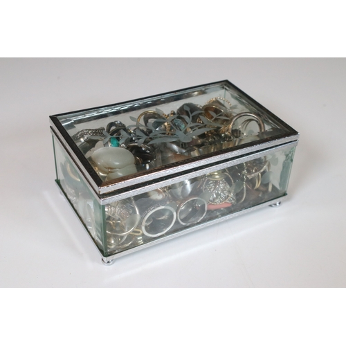 378 - A collection of costume jewellery rings within a glass paneled casket.