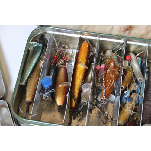 380 - A collection of vintage fishing lures within four boxes.