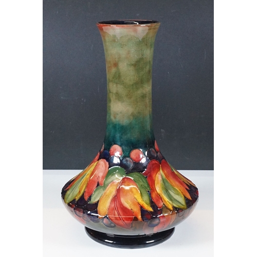 15 - Moorcroft tall compressed bottle form vase in 'Leaf and Berry' design, artist signed to base, stampe... 