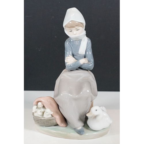 51 - Group of Lladro figurines to include boy with golf clubs, girl with shawl and basket, seated girl wi... 