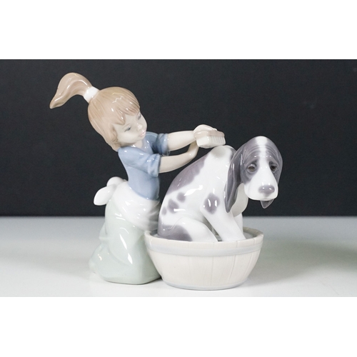 51 - Group of Lladro figurines to include boy with golf clubs, girl with shawl and basket, seated girl wi... 