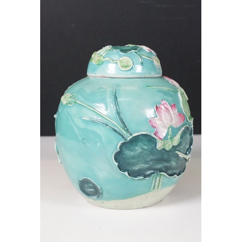 72 - 20th century green glazed lidded ginger jar with applied leaves, flowers and stork, standing on wood... 