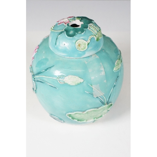 72 - 20th century green glazed lidded ginger jar with applied leaves, flowers and stork, standing on wood... 