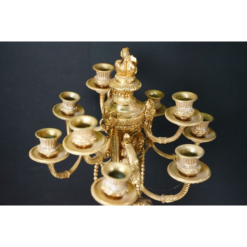 183 - Pair of large golden finish nine branch candelabras with winged cherub, beads, rams head and flame d... 