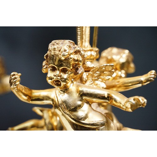 183 - Pair of large golden finish nine branch candelabras with winged cherub, beads, rams head and flame d... 