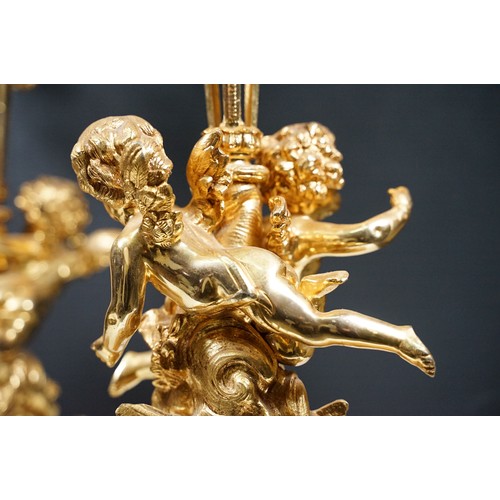 183 - Pair of large golden finish nine branch candelabras with winged cherub, beads, rams head and flame d... 