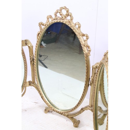 671 - Gilt oval triptych dressing mirror with ribbon decoration, H 70cm