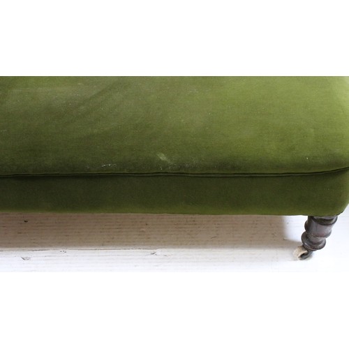 724 - 20th century green chaise longue with buttoned arm and back rail, with turned legs on casters, H 85c... 