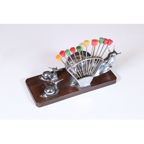 325 - Art Deco chrome cocktail stick holder in the form of fan with one large snail and two trailing snail... 