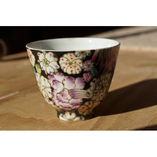 5 - Pair of 19th Century hand enamelled Chinese tea bowls, decorated with florals on a black ground. Bot... 