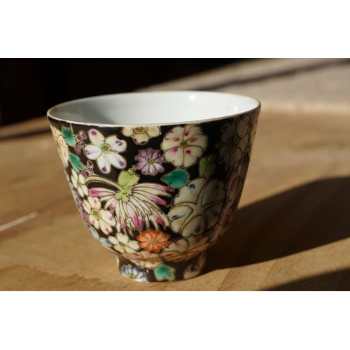 5 - Pair of 19th Century hand enamelled Chinese tea bowls, decorated with florals on a black ground. Bot... 