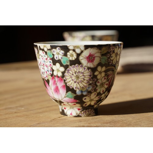 5 - Pair of 19th Century hand enamelled Chinese tea bowls, decorated with florals on a black ground. Bot... 