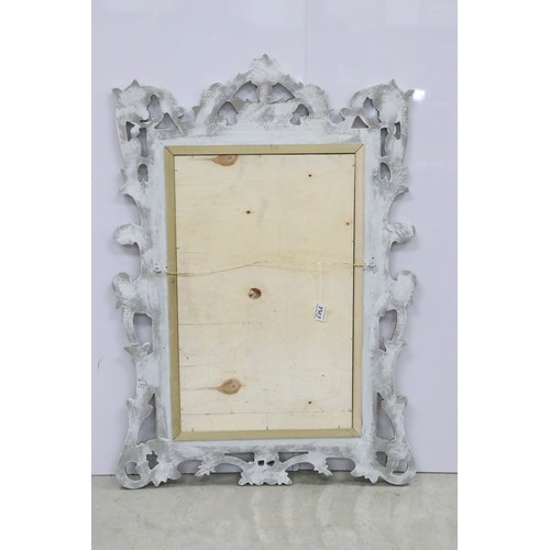 678A - Large composite orante framed mirror with foliate design, measures 94cm x 65.5cm