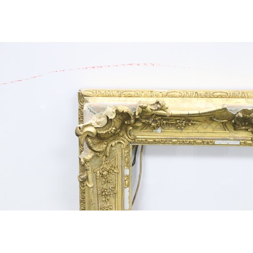 691A - Late 19th / Early 20th Century gilt picture frame with ornately moulded border, measures 67cm x 56cm... 