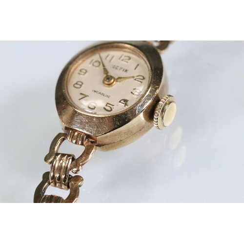 386 - 9ct gold Hefik 9ct gold wrist watch having a round face with arabic numerals to the chapter ring wit... 