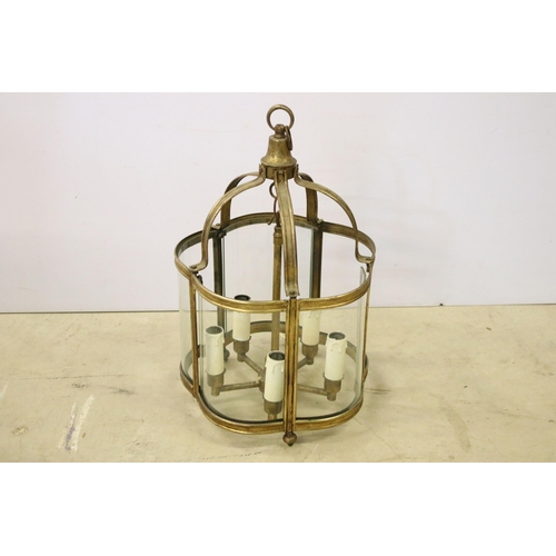432 - Brass ceiling hanging porch light having curved glass panels with four faux candle within. Measures ... 