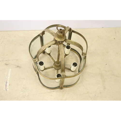 432 - Brass ceiling hanging porch light having curved glass panels with four faux candle within. Measures ... 