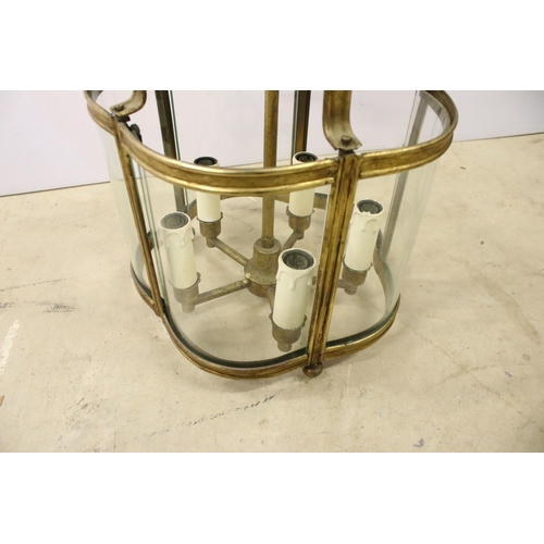 432 - Brass ceiling hanging porch light having curved glass panels with four faux candle within. Measures ... 