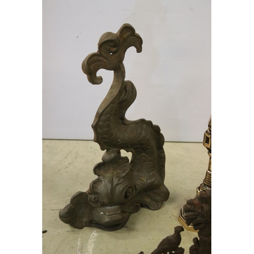 445 - Four cast iron and brass door stops to include 2 x brass Britains Pride examples, cast iron Chinese ... 