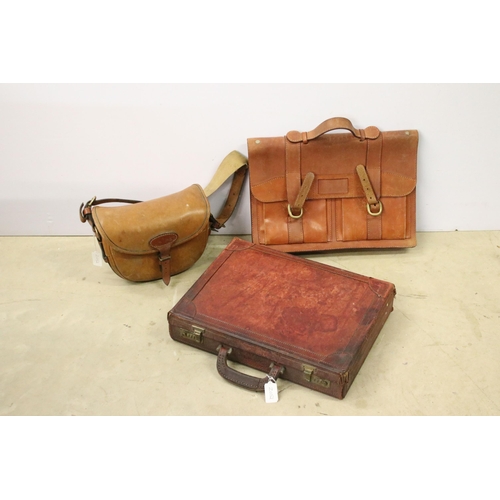 454 - Three leather bags to include two brief cases and a satchel.