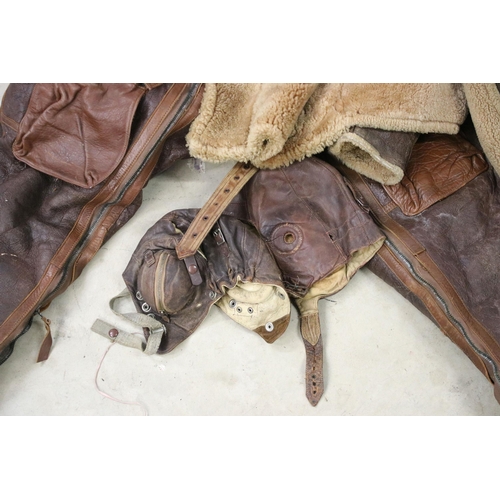 474A - RAF leather flying suit to include trousers, jacket, and two flying helmets.