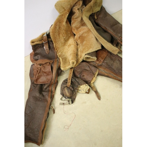 474A - RAF leather flying suit to include trousers, jacket, and two flying helmets.