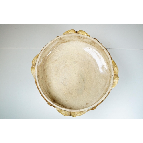 132 - 19th century majolica pedestal bowl, the bowl decorated with horned masks and putti, raised on colum... 