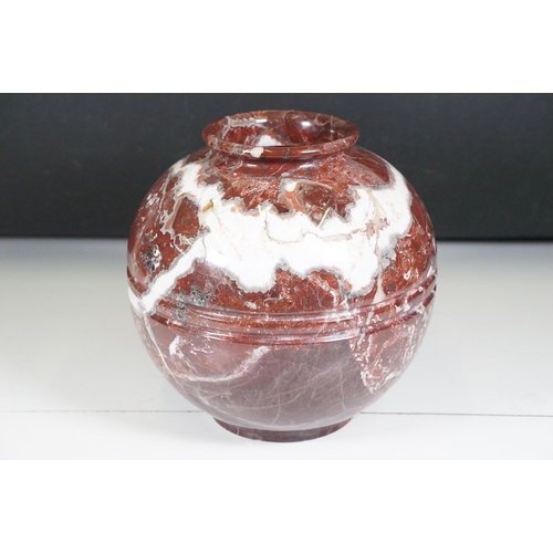 139 - Polished marble vase of spherical footed form, with tones of red and off-white, moulded rim and doub... 