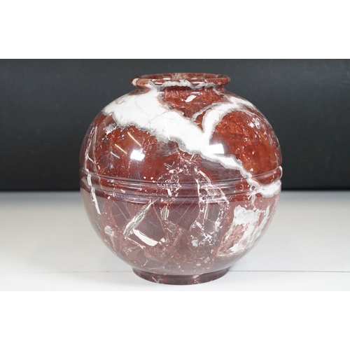 139 - Polished marble vase of spherical footed form, with tones of red and off-white, moulded rim and doub... 