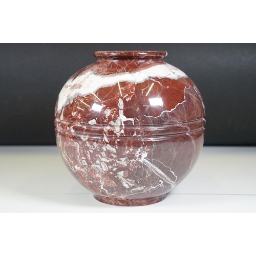 139 - Polished marble vase of spherical footed form, with tones of red and off-white, moulded rim and doub... 