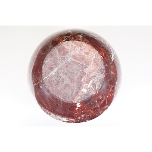 139 - Polished marble vase of spherical footed form, with tones of red and off-white, moulded rim and doub... 