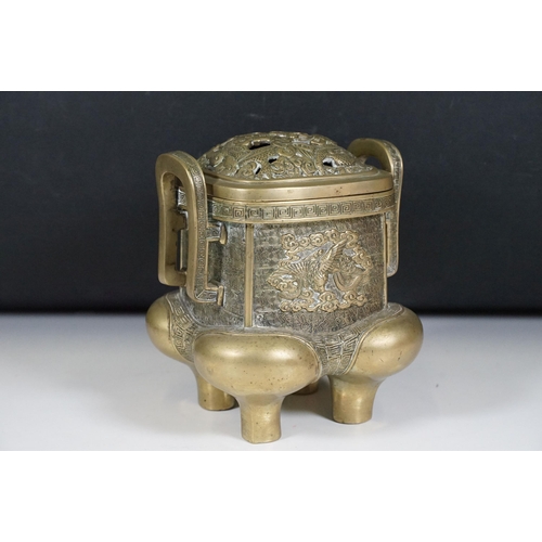 141 - Chinese bronzed lidded censer with dragon and traditional detailing, with twin handles on four legs,... 