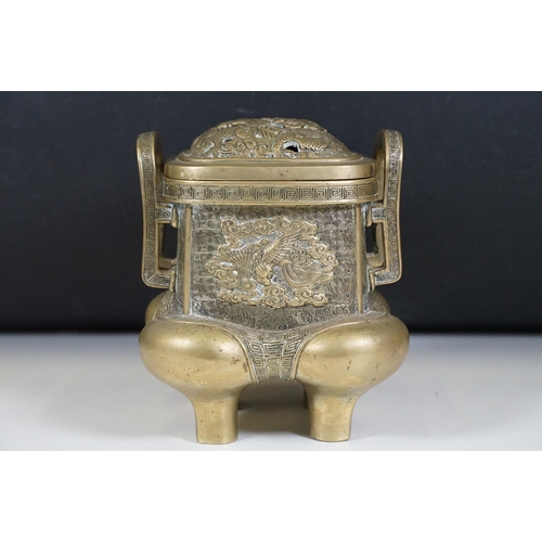 141 - Chinese bronzed lidded censer with dragon and traditional detailing, with twin handles on four legs,... 