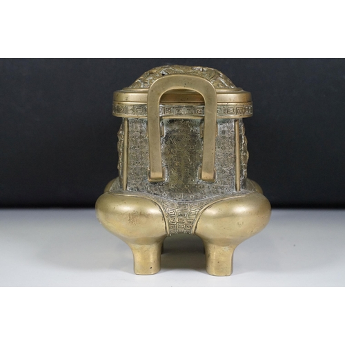 141 - Chinese bronzed lidded censer with dragon and traditional detailing, with twin handles on four legs,... 