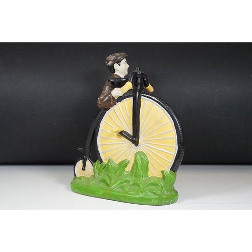 146 - Cast plaster figurine in the form of a gentleman with a penny farthing, hand painted. Measures 35cm ... 