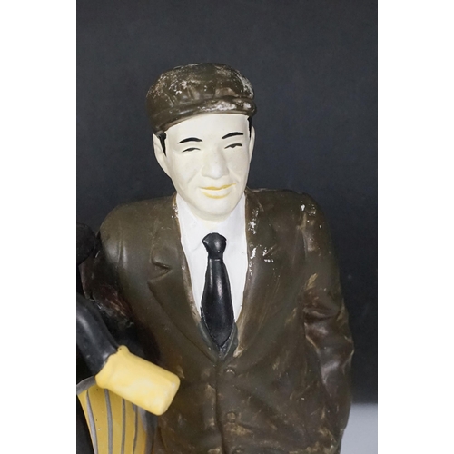 146 - Cast plaster figurine in the form of a gentleman with a penny farthing, hand painted. Measures 35cm ... 