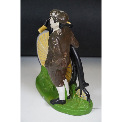 146 - Cast plaster figurine in the form of a gentleman with a penny farthing, hand painted. Measures 35cm ... 