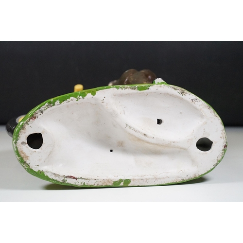 146 - Cast plaster figurine in the form of a gentleman with a penny farthing, hand painted. Measures 35cm ... 