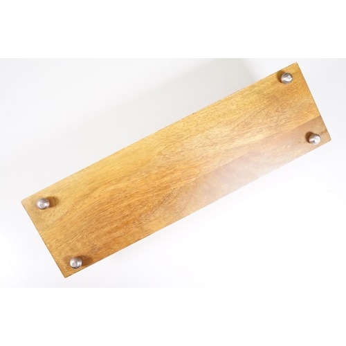 152 - Wooden bookstand with cast metal supports in the form of running foxes, on four ball feet, 44cm long