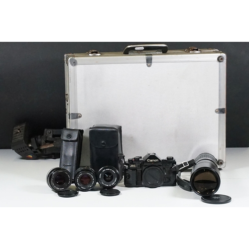 441 - Collection of cameras, lenses and equipment contained within a padded case to include Canon A-1 35mm... 