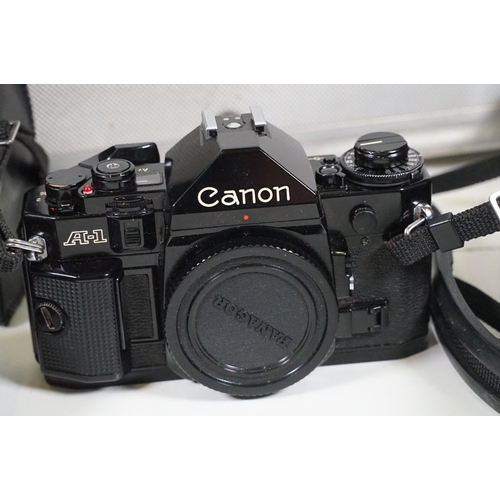 441 - Collection of cameras, lenses and equipment contained within a padded case to include Canon A-1 35mm... 