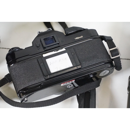 441 - Collection of cameras, lenses and equipment contained within a padded case to include Canon A-1 35mm... 