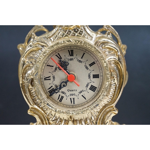 419 - Brass reproduction mantle clock together with matching candelabras