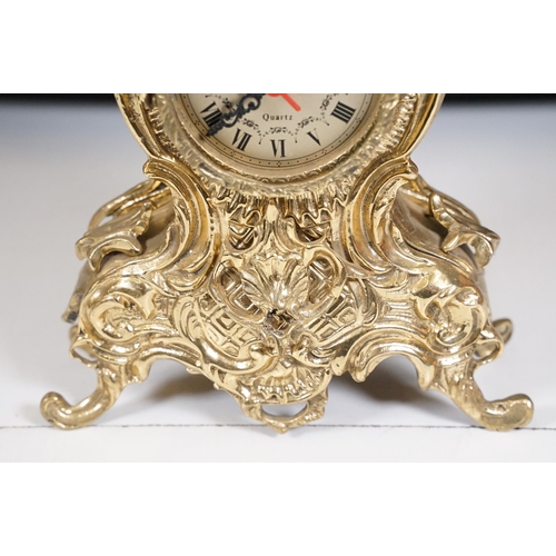 419 - Brass reproduction mantle clock together with matching candelabras