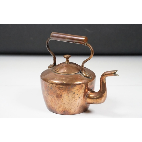 424 - Two Late 19th Century copper teapots, one with turned wooden handle